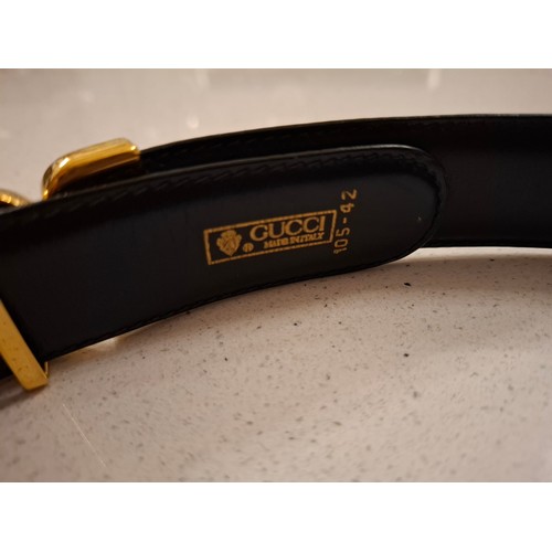 4 - Gucci- A black leather belt with gold tone double GG buckle, made in Italy, waist measurement 81cm -... 