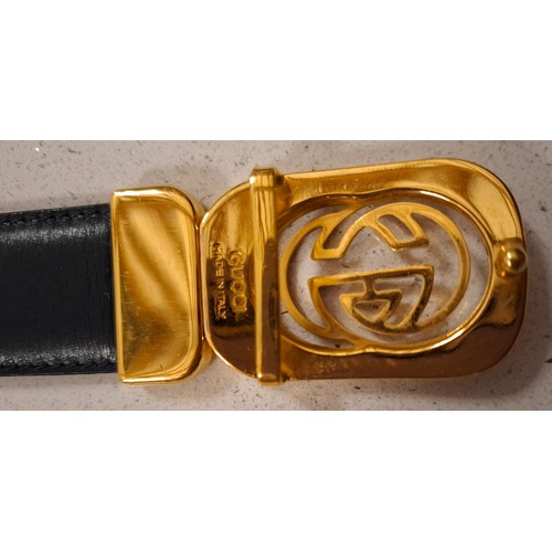 4 - Gucci- A black leather belt with gold tone double GG buckle, made in Italy, waist measurement 81cm -... 