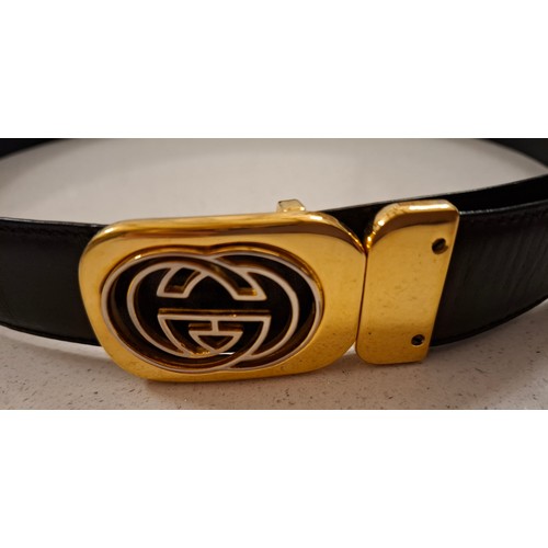 4 - Gucci- A black leather belt with gold tone double GG buckle, made in Italy, waist measurement 81cm -... 