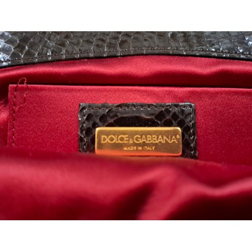 18 - Dolce & Gabbana- A vintage brown and black silk occasional handbag having gold tone hardware and ros... 