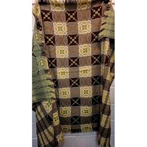 49 - A vintage Welsh woollen blanket in green, black, cream and yellow having a geometric pattern to both... 