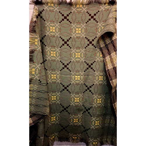 49 - A vintage Welsh woollen blanket in green, black, cream and yellow having a geometric pattern to both... 