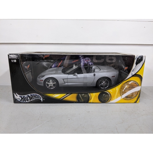 335 - Two boxed Hotwheels models, a Damon Hill's Jordan 199 F1 car, together with a silver Corvette Locati... 