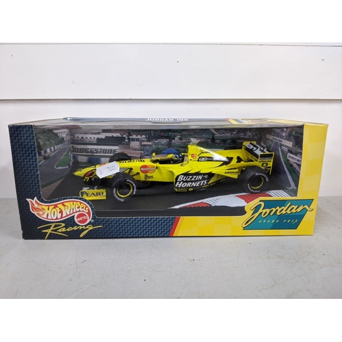 335 - Two boxed Hotwheels models, a Damon Hill's Jordan 199 F1 car, together with a silver Corvette Locati... 