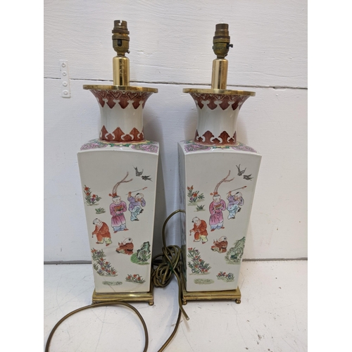 285 - A pair of mid century Chinese converted table lamps decorated with traditional oriental scenes 57cmh... 