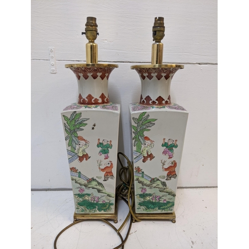 285 - A pair of mid century Chinese converted table lamps decorated with traditional oriental scenes 57cmh... 