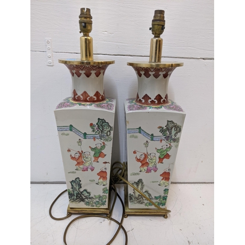 285 - A pair of mid century Chinese converted table lamps decorated with traditional oriental scenes 57cmh... 