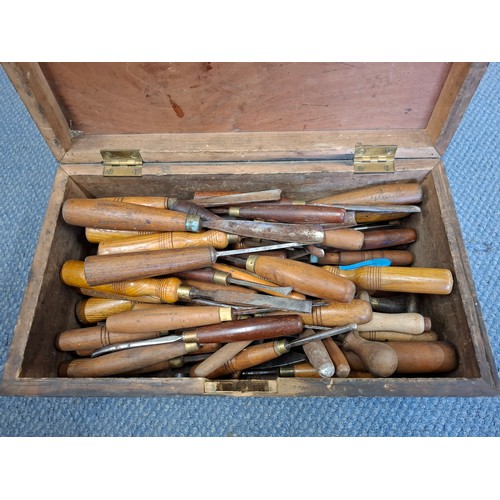 232 - A stained vintage wooden tool box and contents to include wooden handled chisels and carving scoops ... 