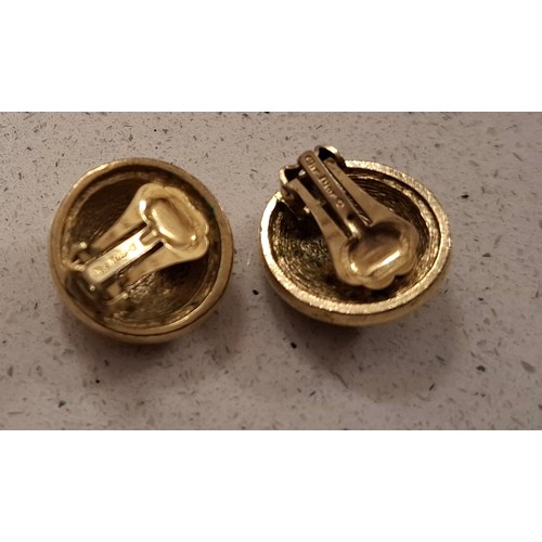 8 - Christian Dior-A pair of gold tone clip on earrings of circular form with CD monogram design. Locati... 