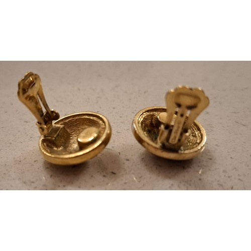 8 - Christian Dior-A pair of gold tone clip on earrings of circular form with CD monogram design. Locati... 