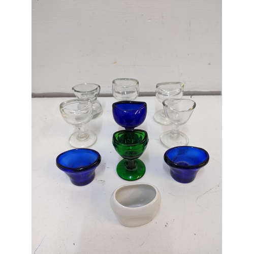 198 - A collection of Victorian eye baths to include cobalt blue examples, a ceramic example and others.

... 