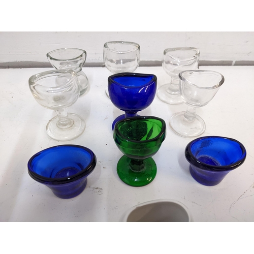 198 - A collection of Victorian eye baths to include cobalt blue examples, a ceramic example and others.

... 