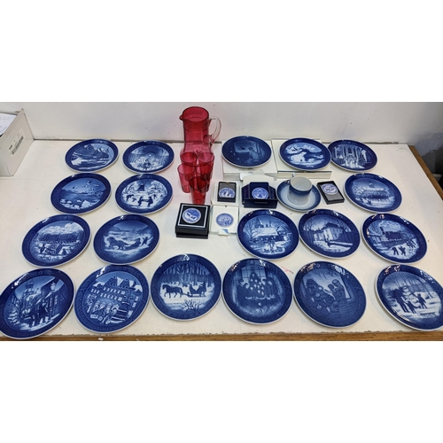 204 - A mixed lot to include Royal Copenhagen Christmas plates; plaques; a cranberry jug; glass set.

Loca... 