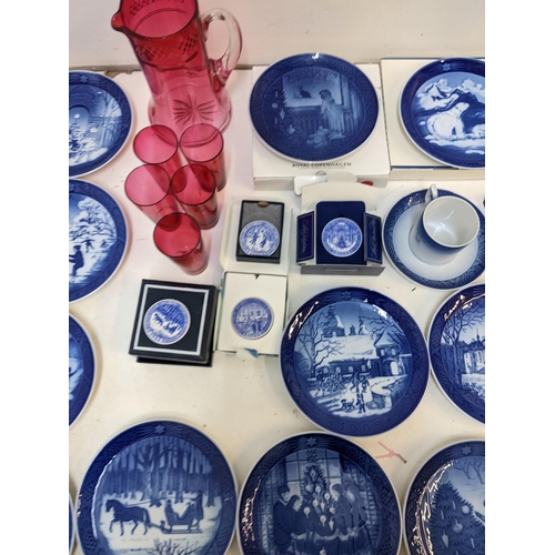 204 - A mixed lot to include Royal Copenhagen Christmas plates; plaques; a cranberry jug; glass set.

Loca... 