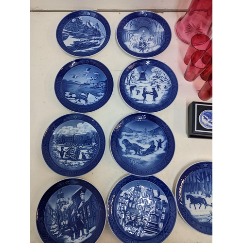 204 - A mixed lot to include Royal Copenhagen Christmas plates; plaques; a cranberry jug; glass set.

Loca... 