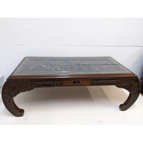 214 - An Oriental South Asian rosewood opium table with an ornate carving, depicting a river scene behind ... 