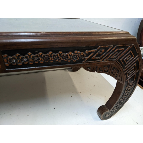 214 - An Oriental South Asian rosewood opium table with an ornate carving, depicting a river scene behind ... 