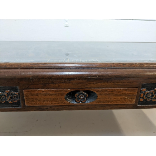 214 - An Oriental South Asian rosewood opium table with an ornate carving, depicting a river scene behind ... 