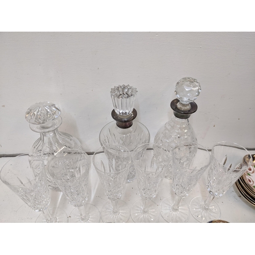 218 - A mixed lot to include some crystal cut glass decanters, two with hallmarked silver collars, a Royal... 