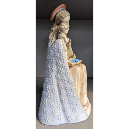 228 - A Hummel ceramic figurine of a Madonna and child, Madonna wearing a long blue gown and pale pink dre... 