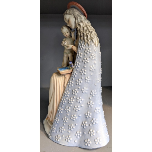 228 - A Hummel ceramic figurine of a Madonna and child, Madonna wearing a long blue gown and pale pink dre... 