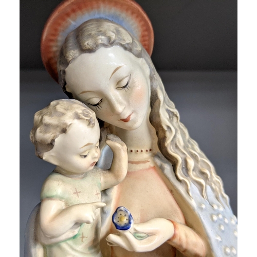 228 - A Hummel ceramic figurine of a Madonna and child, Madonna wearing a long blue gown and pale pink dre... 