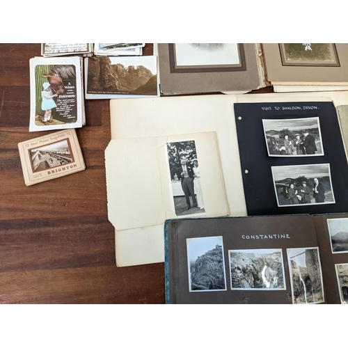 248 - A collection of early 20th century photograph albums along with vintage postcards
Location: 3-1
If t... 