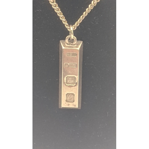 26 - A 9ct yellow gold ingot pendant on a 9ct yellow gold flat curb link chain 60cm L 23.7g
Location:CAB2... 