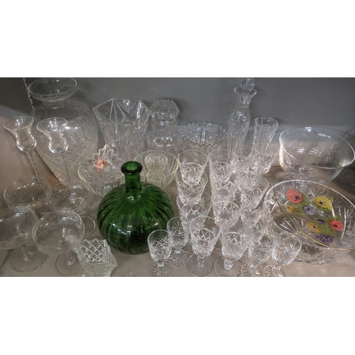 266 - A quantity of crystal cut glassware to include decanters, vases, bowls and drinking glasses together... 