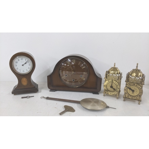 268 - Four clocks to include an Edwardian inlaid mahogany Balloon clock along with a Smith's dining room m... 