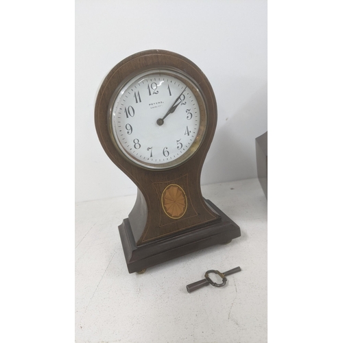 268 - Four clocks to include an Edwardian inlaid mahogany Balloon clock along with a Smith's dining room m... 