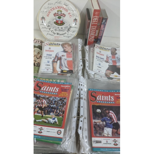 428 - Southampton FC related memorabilia to include: two folders of programmes dating mostly from the late... 