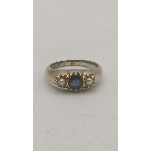 47 - A yellow metal sapphire and pearl ladies ring, central blue oval sapphire in a six claw setting, fla... 