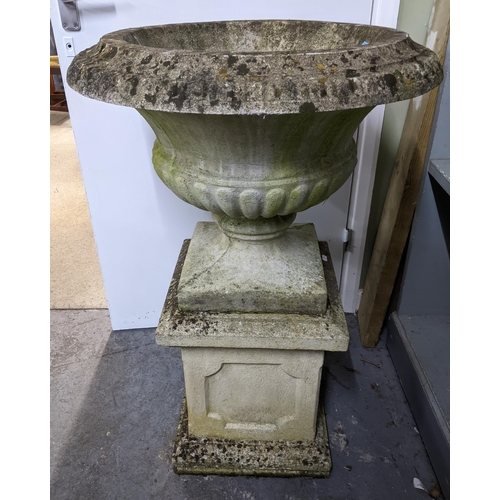 194 - A weathered concrete garden pedestal urn on a square pedestal base, 93cm high, 61cm diameter to top ... 