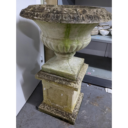 194 - A weathered concrete garden pedestal urn on a square pedestal base, 93cm high, 61cm diameter to top ... 