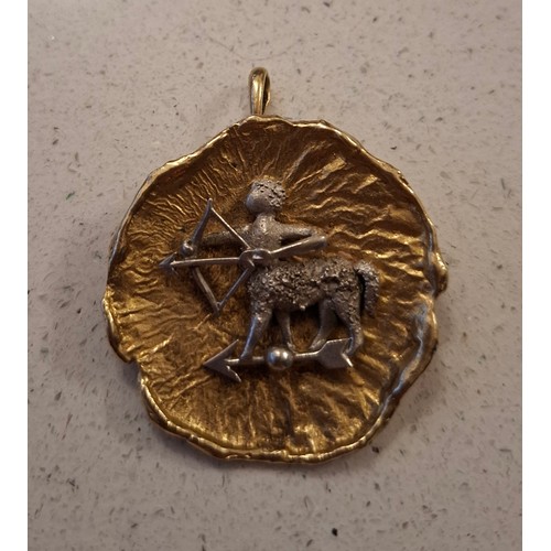 47 - A Sagittarius bi-coloured pendant with additional brooch pin to the reverse having a 9ct gold curb l... 