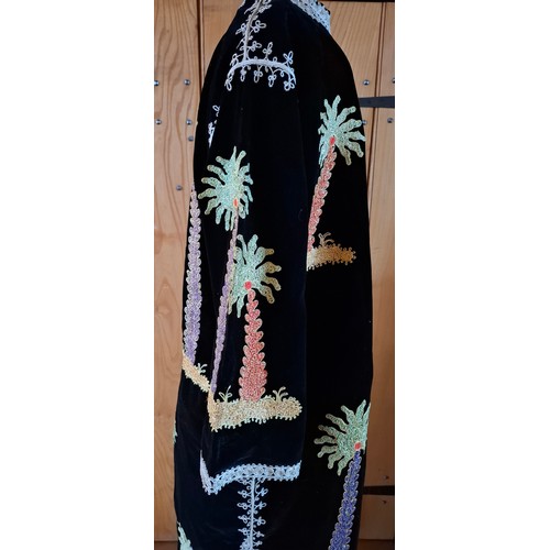 71 - A 1970's Asian black velveteen and embroidered robe having images of palm trees embroidered with met... 