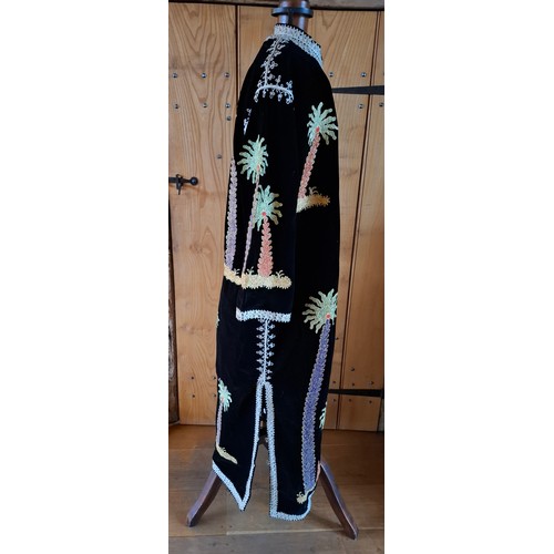 71 - A 1970's Asian black velveteen and embroidered robe having images of palm trees embroidered with met... 