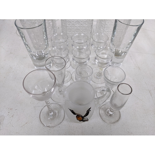 376 - A collection of glassware to include three 20th century crystal cut decanters, a set of six liqueur ... 