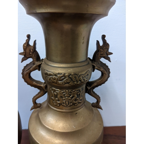 439 - A pair of Oriental brass urns with twin handles fashioned as dragons, approx. 40cm high Location: GM... 