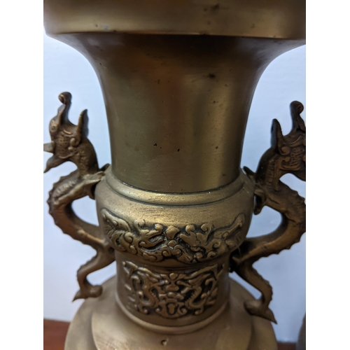 439 - A pair of Oriental brass urns with twin handles fashioned as dragons, approx. 40cm high Location: GM... 