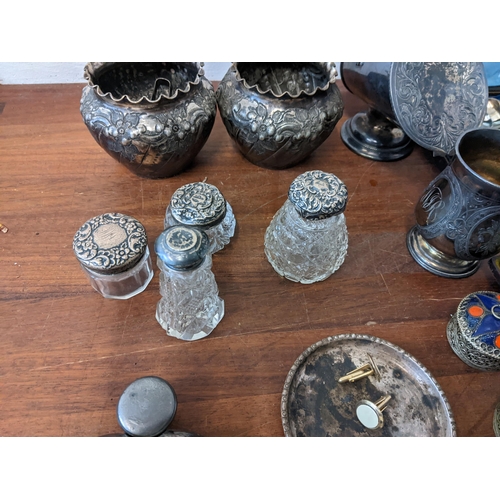 443 - A mixed lot of metalware to include crystal glass dressing table pots with silver lids, a cased silv... 