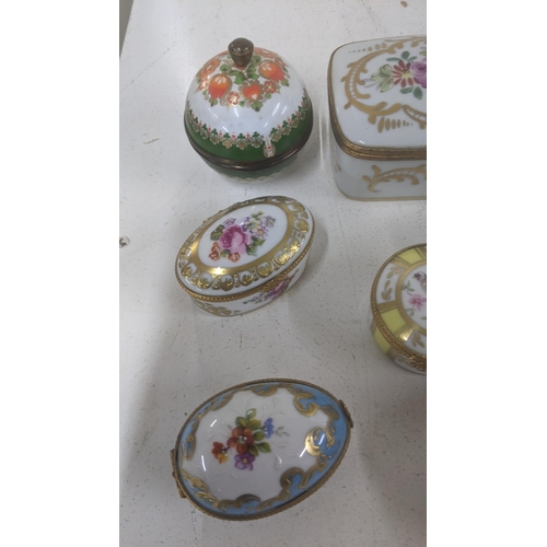 468 - A group of Limoges trinkets and small dressing table box together with one other along with a Limoge... 