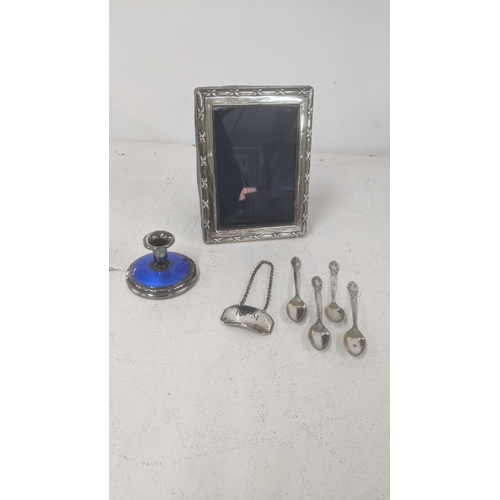 494 - Silver items to include a Georgian Rum wine label, silver enamelled dwarf candleholder, photograph f... 