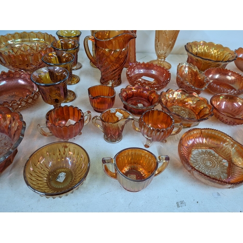 497 - A collection of Marigold carnival glass to include bowls, goblets, vases, jugs and other items Locat... 