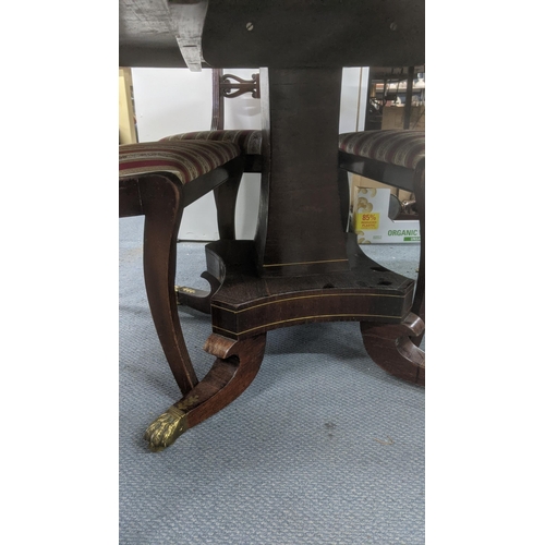 498 - A Regency rosewood breakfast table with brass inlay, 71cm h x 121cm d together with a set of four re... 