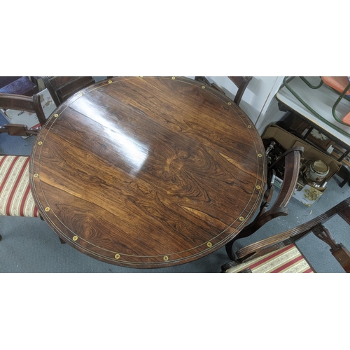 498 - A Regency rosewood breakfast table with brass inlay, 71cm h x 121cm d together with a set of four re... 