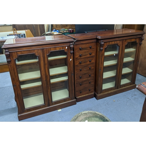 192 - An unusual three-section Victorian mahogany breakfront bookcase, the centre section of seven drawers... 