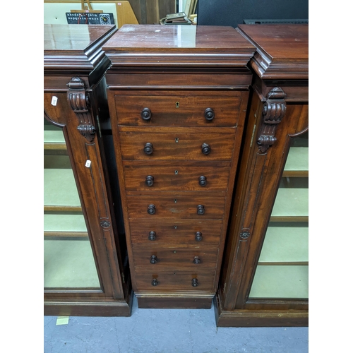 192 - An unusual three-section Victorian mahogany breakfront bookcase, the centre section of seven drawers... 