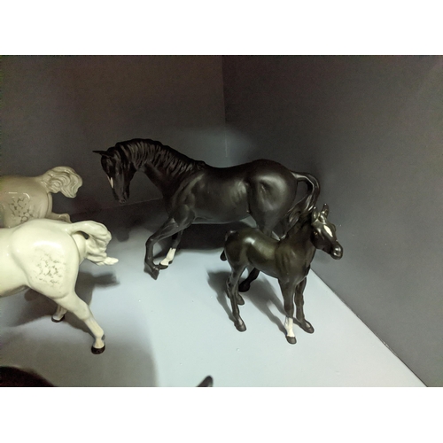 349 - A collection of Beswick and Royal Doulton horses and foals, along with a Franklin Mint model of Blac... 